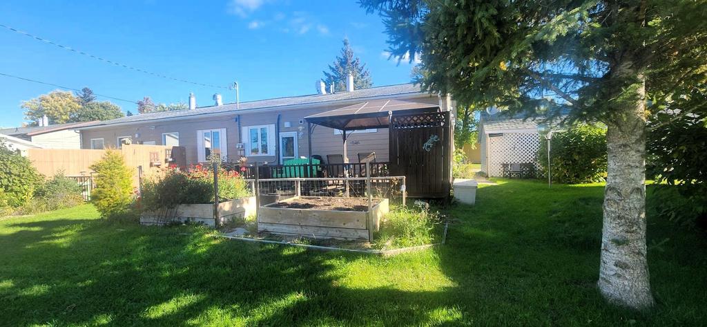 82 Willow Drive, Aspen Park &middot; the back lawn and deck under mature trees