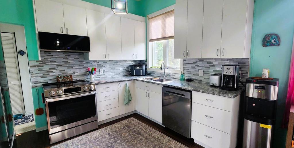 82 Willow Drive, Aspen Park &middot; renovated kitchen with white cabinets and stainless appliances