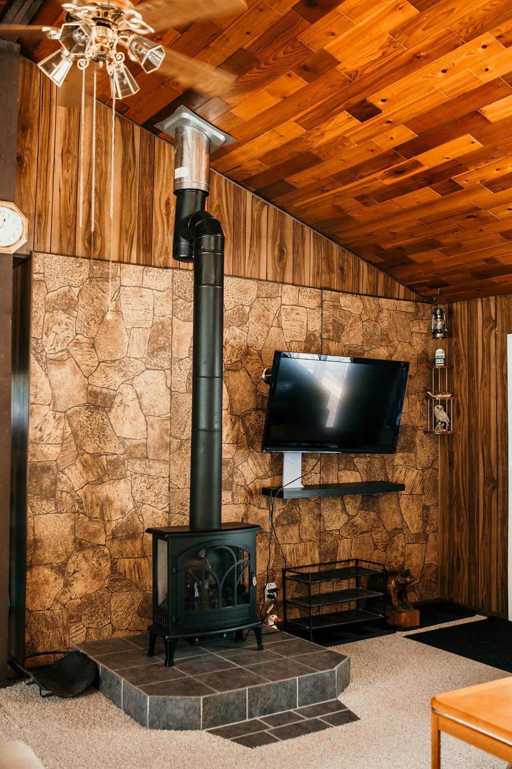 899 PTH 9 Highway, Winnipeg Beach &middot; wood stove on a stone surround in the living room